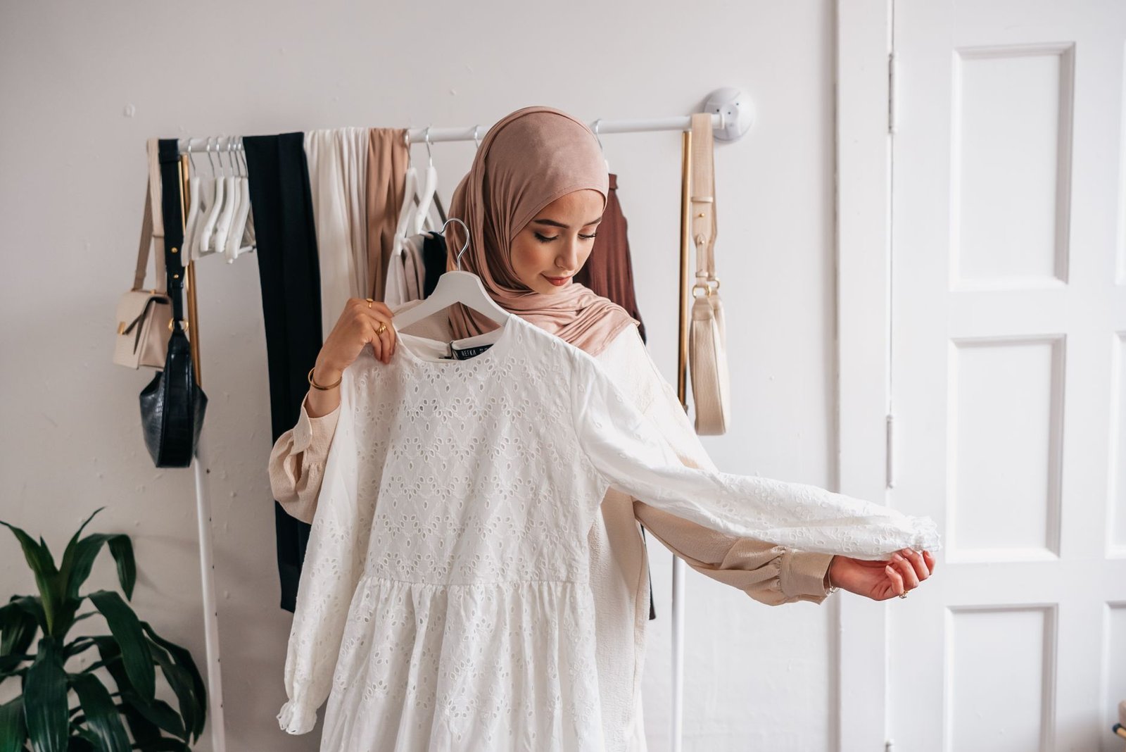 Woman trying on a garment in a boutique fitting room
