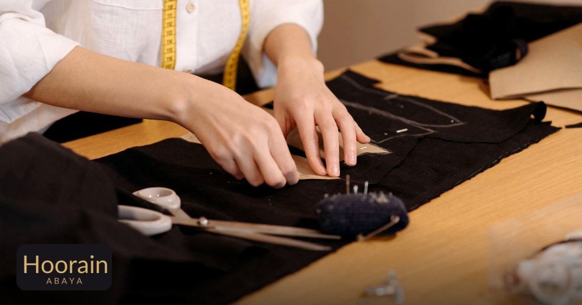 Abaya Length Guide: Find the Perfect Hem for Your Height and Shoes - close-up of a tailor cutting fabric on a workspace