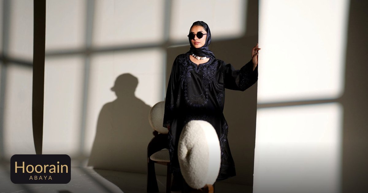 Evening Abaya Styling: Chic Looks for Dinners, Weddings & Events - an elegant woman in black embroidered dress poses