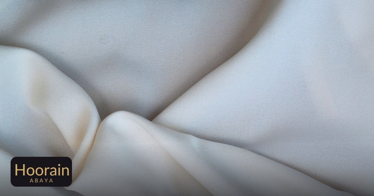 Best Abaya Fabrics for GCC Climate: Crepe, Silk & Linen Guide - close-up of soft white silk fabric with gentle folds