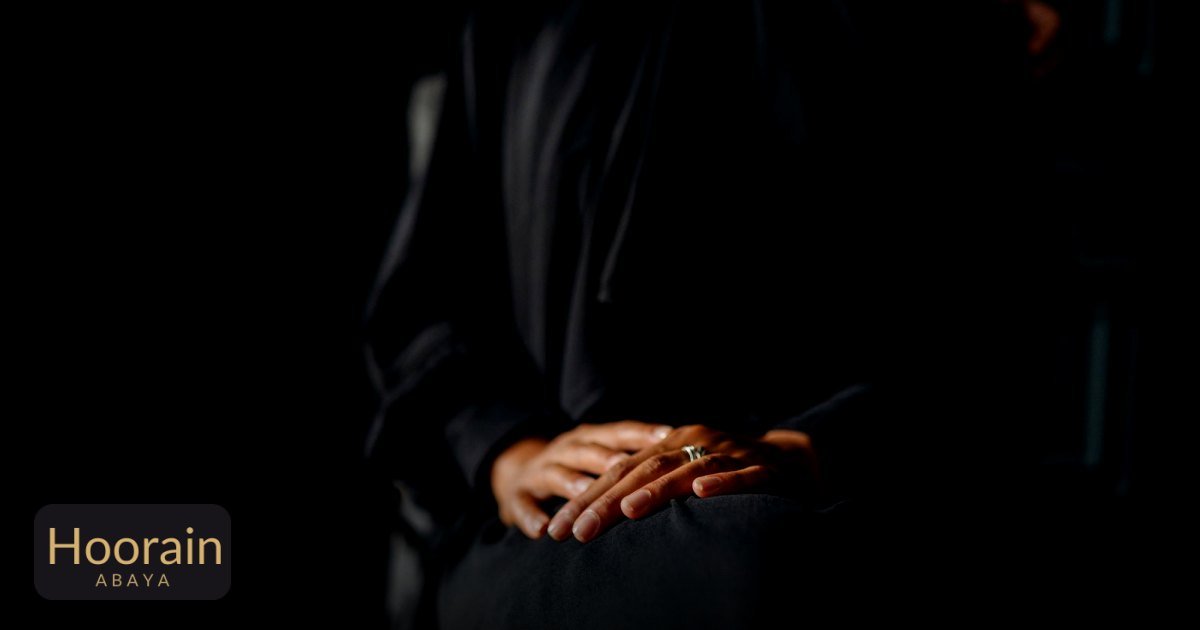 What Fabric Is Best for an Abaya in Hot Weather? - elegant woman in abaya sitting with hands resting gracefully